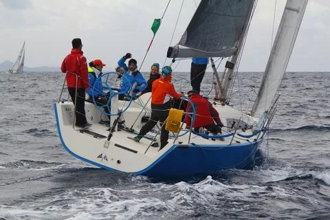 Sailboats sail in windy weather in the blue waters of the Aegean Sea Stock Photos
