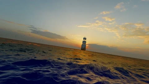 Sailboats sailing away from the sea at sunset Stock Footage 182302953
