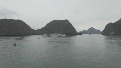Sailing along calm waters on a cloudy day at halong bay Stock Footage 287595565