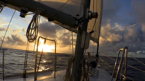 Sailing and rolling in open ocean at sunset. Stock Footage 107972190