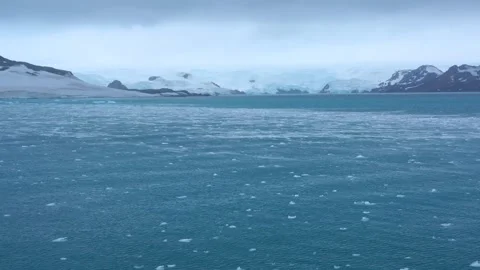 Sailing Antarctica Cloudy Day with Floating Ice Bergs Snow Covered Mountain.. Stock Footage 340303077