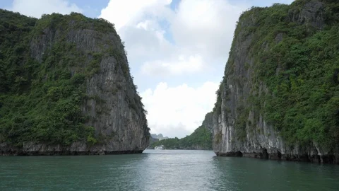 Sailing between two rock. Tourist cruise at Ha long Bay in Vietnam. Stock Footage 110703815
