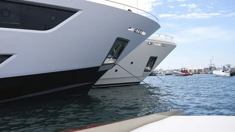 Sailing by big yacht in port of Cannes Yacht show Stock Footage