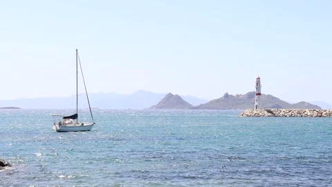 Sailing Boat and Lighthouse in the Bay (Slowmotion) Stock Footage