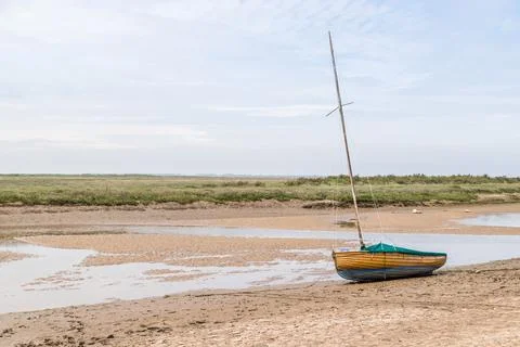 Sailing boat beached at low tide at Blakeney Stock Photos