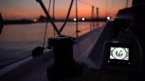Sailing boat getting close to marina at sunset, view from cockpit Stock Footage 120422243
