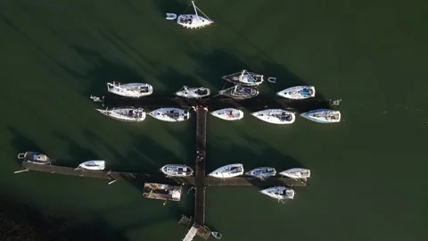 Sailing boat harbor with passing sailing boat aerial Stock Footage 255945552