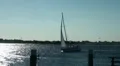 Sailing boat leaving Fehmarn island coast windy day HD Footage
