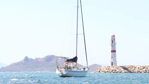 Sailing Boat by the Lighthouse (4K) Stock Footage 236661739