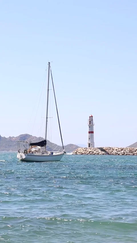 Sailing Boat by the Lighthouse (Vertical) Stock Footage 236660457