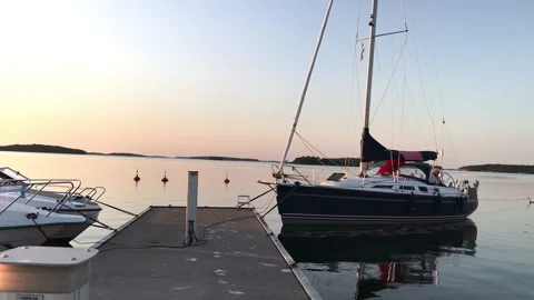 Sailing boat, motor boats and a ferry on a quiet marina, Archipelago of Finland Stock Footage 169353953