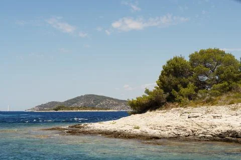 Sailing boat navigating clear turquoise waters off croatian coast Stock Photos