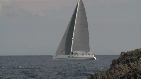 Sailing boat navigating close to the coast  Stock Footage 46942804