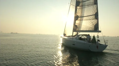 Sailing boat navigating with open sails at the sunset Stock Footage 68458291