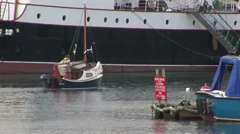 Sailing boat next to large container ship Stock Footage 61575701