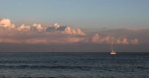 Sailing Boat On The Sea At Sunset With Dramatic Clouds In Barcelona 4K Stock Footage 131566215