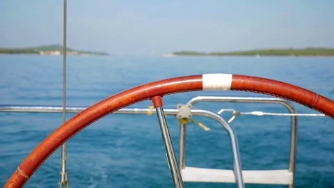 Sailing boat steering wheel closeup with beautiful blue Adriatic sea. Stock Footage 82565907