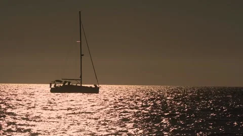 Sailing boat stopped in the sunset Stock Footage 65442800