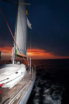 Sailing boat at sunset Stock Photos