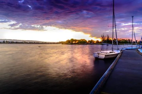 Sailing boat at sunset Stock Photos