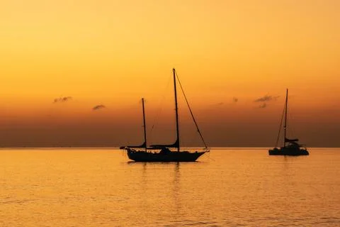 Sailing boat at sunset Stock Photos