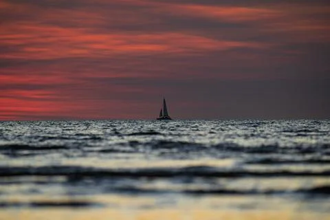 Sailing boat at sunset Stock Photos
