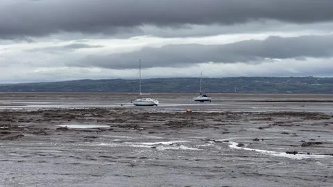 Sailing boats sand low tide grey sky Stock Footage 244774856