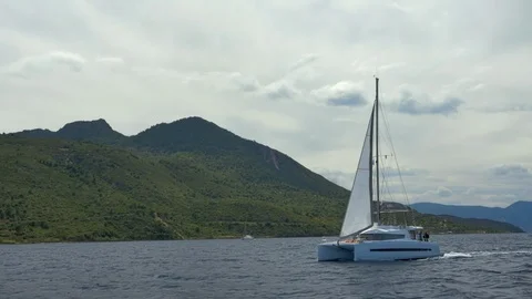 Sailing catamaran on the background of the island. Stock Footage 103540477