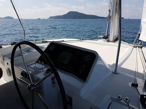 Sailing catamaran control panel - steering wheel and navigation equipment Stock Photos