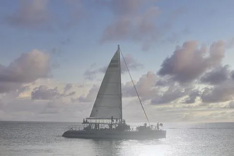 Sailing catamaran at sunset Stock Photos