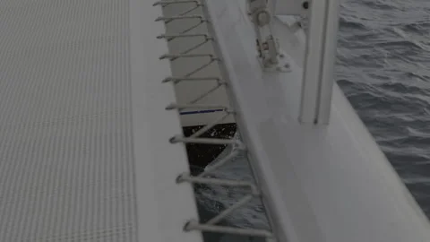 Sailing catamaran in winter. Water splashes against the left bow of the boat. Video stock 198370909