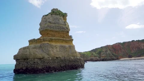 Sailing close past massive rock formation near cliffs in Portugal Stock Footage 273286206