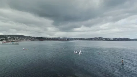 Sailing Club training at cloudy sky from a drone, Paignton, Devon, UK 動画素材 236324557