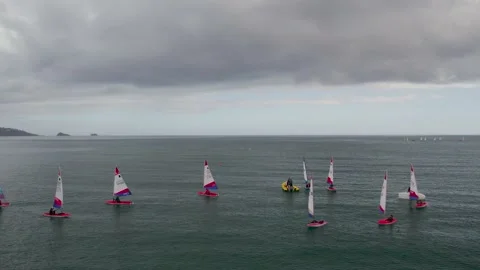 Sailing Club training at cloudy sky from a drone, Paignton, Devon, UK Stock Footage 236433417