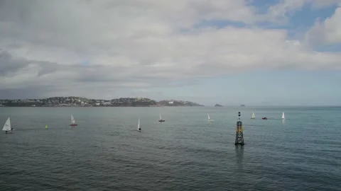 Sailing Club training at cloudy sky from a drone, Paignton, Devon, UK Stock Footage 236471546