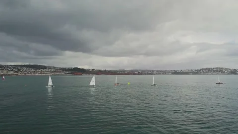 Sailing Club training at cloudy sky from a drone, Paignton, Devon, UK Stock Footage 236471628