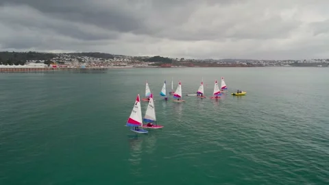 Sailing Club training at cloudy sky from a drone, Paignton, Devon, UK Stock Footage 236471686