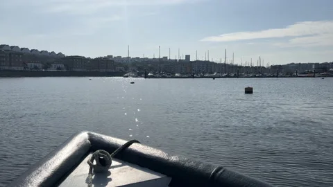 Sailing into a harbour on a boat Stock Footage 239655488