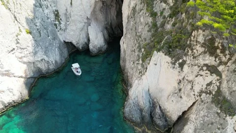 Sailing Heights: 4K Drone Perspective of Cliffs and White Boat Видео 250029955
