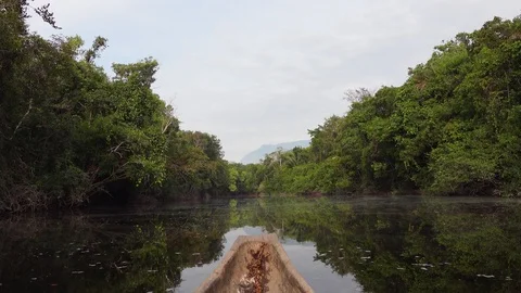 Sailing on Indigenous canoe in Corocoro river. Amazon state Venezuela Stock Footage 126202289