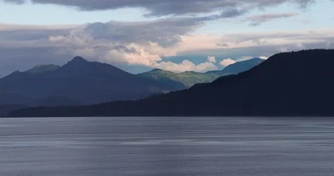Sailing Inside Passage sun lights clouds and distant mountain Stock Footage 208187656