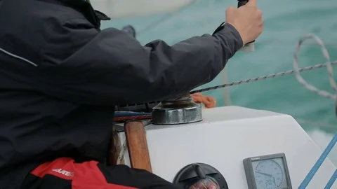 Sailing, man pulling ropes, winding sheets around winches Video stock 78541023