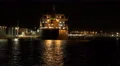 Sailing Past Cargo Ship A Port On Dark Night 4k or 4k+ Resolution