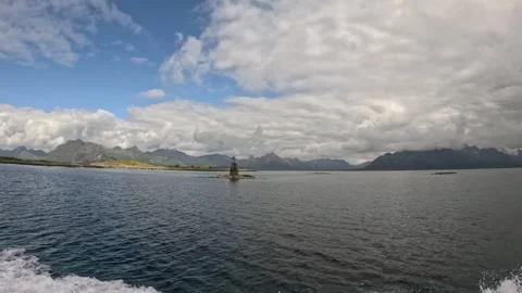 Sailing past coastal navigation beacon in Norwegian fjord Lofoten Stock-Footage 344047574