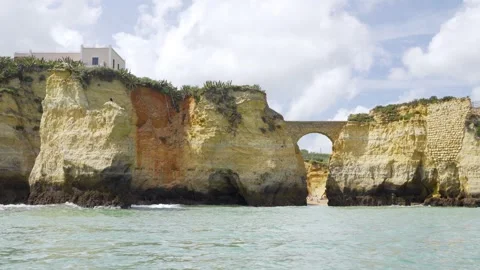 Sailing past eroding rock formation with strong winds and waves in Portugal Stock Footage 273075379