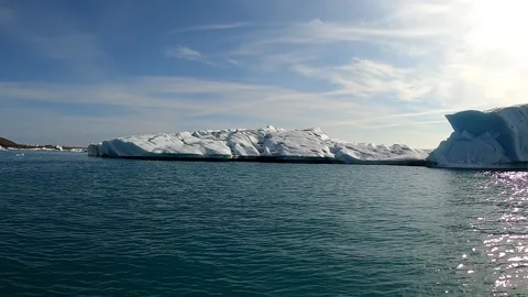 Sailing past giant ancient ice structures in Iceland's glacier lagoon Stock Footage 333993359