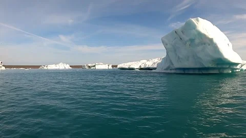 Sailing past giant ancient ice formations in Iceland's glacier lagoon Stock Footage 334045826