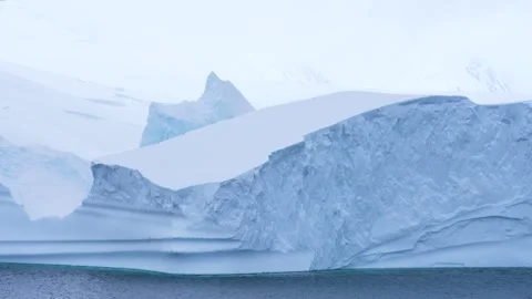 Sailing Past Giant Iceberg Close Up Reveal Wall of Snow and Ice Behind Stock Footage 277919019