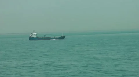 Sailing past small cargo ship at sea Stock-Footage 12411029