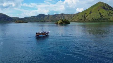 Sailing phinisi boats, pristine tropical paradise. Dramatic aerial view drone Stock-Footage 344617545